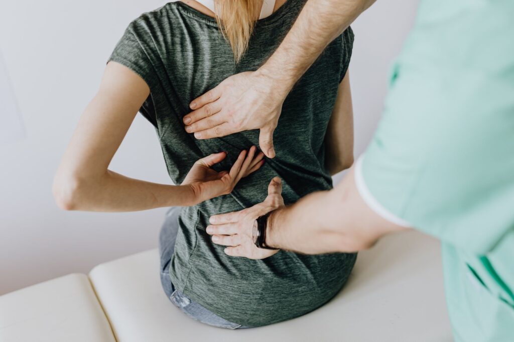 Doctor examining a patient back