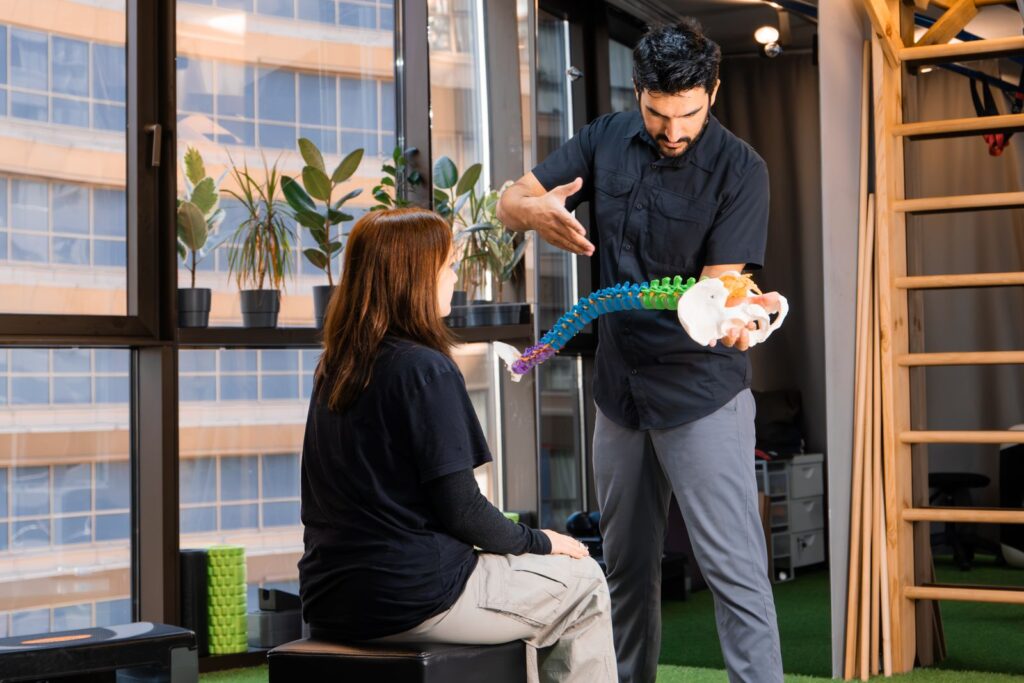 Chiropractor demonstrating with a spine model
